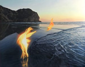 Painting of a flame on a beach at sunset